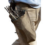 Person wearing beige pants with a tool belt dump pouch holding sticks on a white background